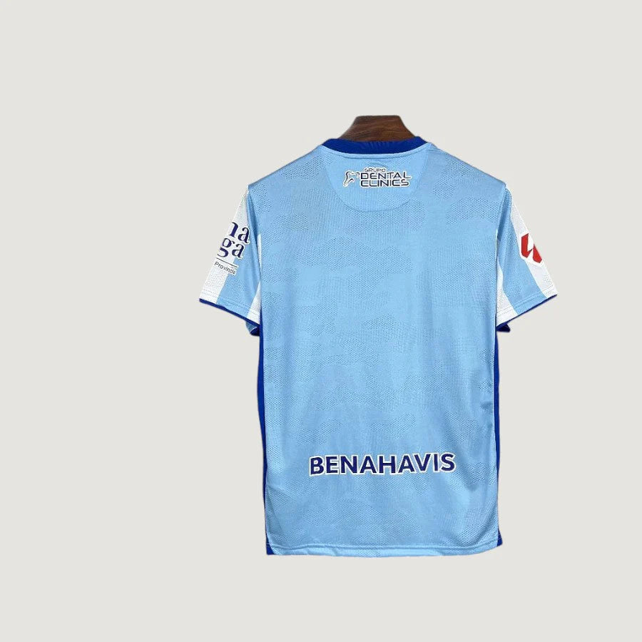 Málaga CF – Home Shirt 25/26 – Light Blue & White
